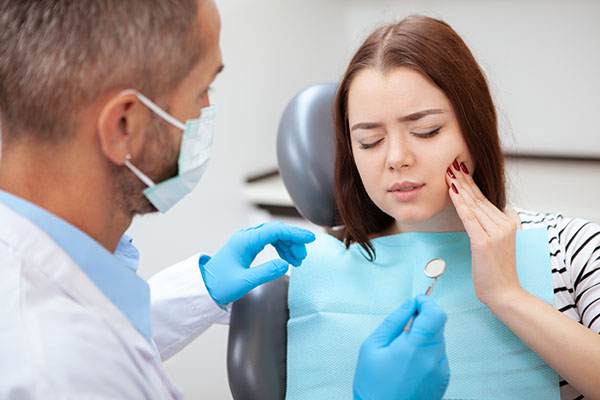 Beautiful young woman visiting dentist for medical checkup Dr. Peter Servinis